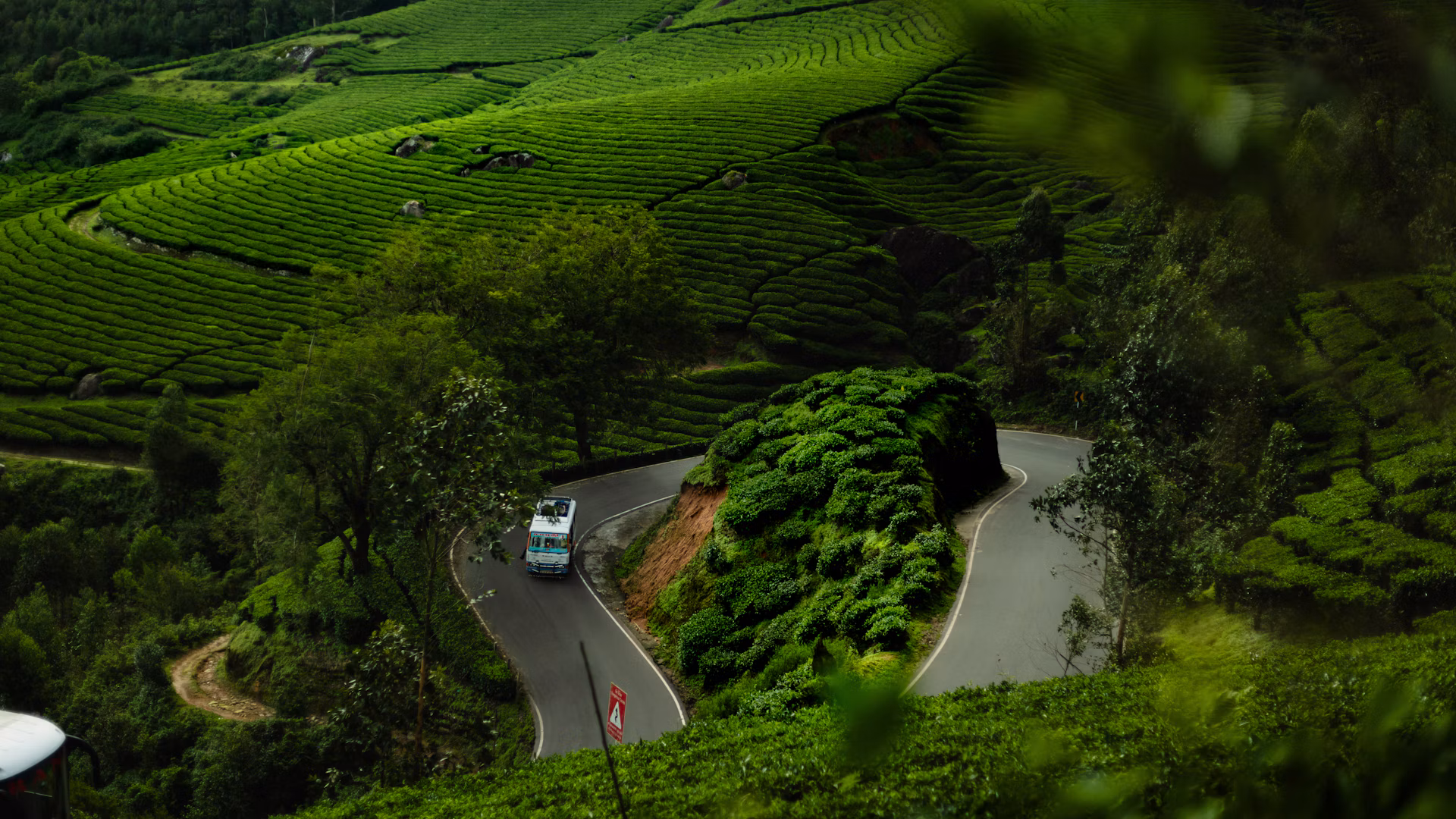 Chauffeur-driven car on a hill road in Kerala