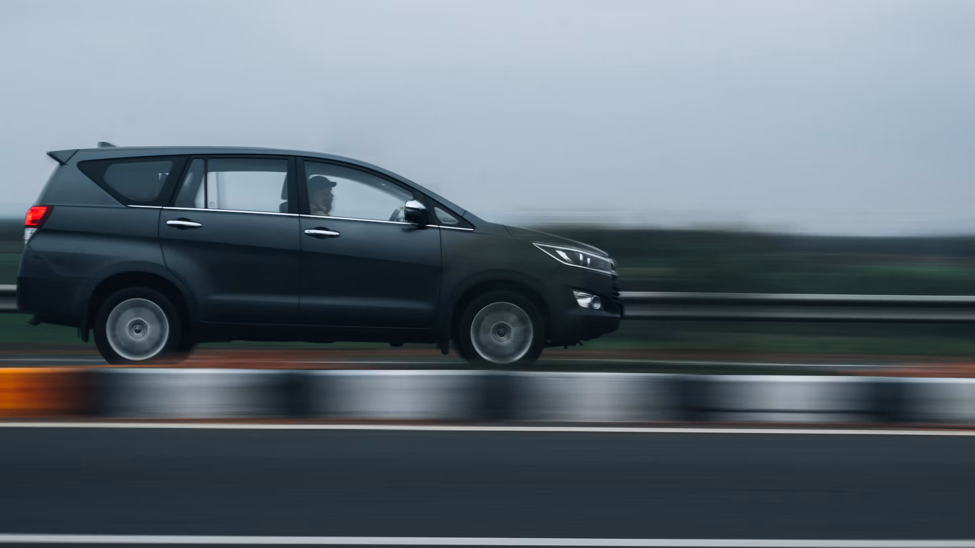 Toyota Innova driving on a highway – outstation cab from Kochi